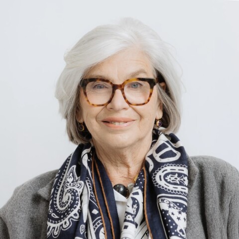 Studio portrait of DLD conference co-founder Steffi Czerny in front of a neutral grey background