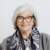 Studio portrait of DLD conference co-founder Steffi Czerny in front of a neutral grey background