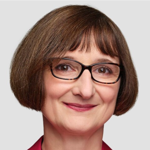 Studio portrait of IBM researcher Heike Riel in front of a light grey background