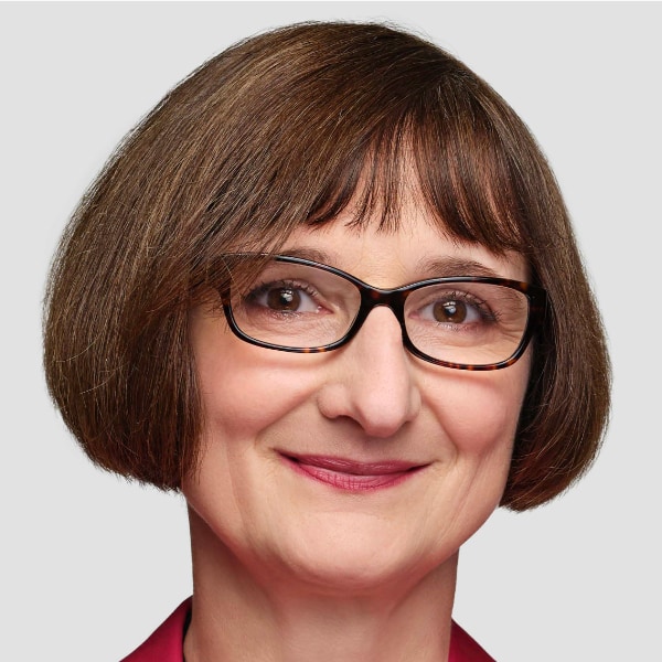 Studio portrait of IBM researcher Heike Riel in front of a light grey background