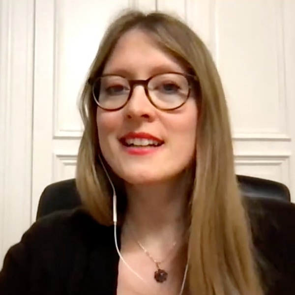 Portrait of Laura Brämswig, seen wearing headphones, speaking at a DLD All Stars teleconference.