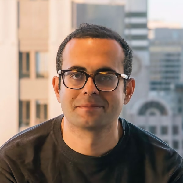 Profile image of Joshua Browder, founder of DoNotPay, seen in front of an urban landscape.