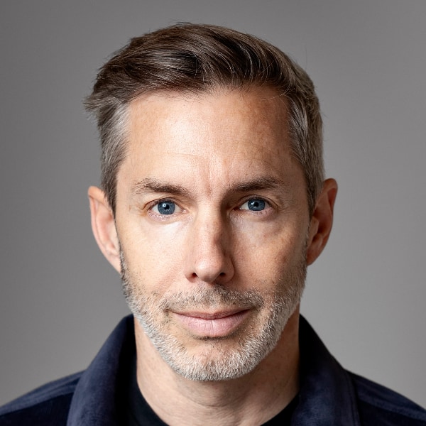 Close-up portrait of Joram Voelklein, Founding Partner of Alpine Space Ventures, in front of a grey studio background.