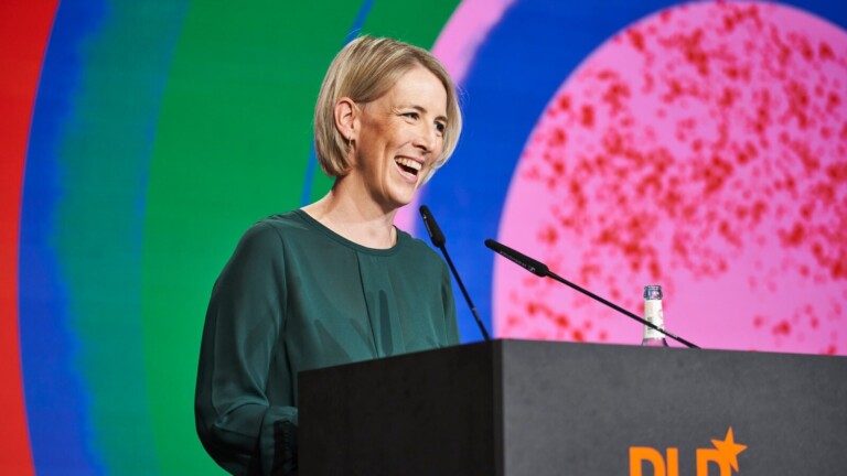 Munich mayor Katrin Habenschaden speaks at DLD Circular 2023 in front of a colorful background