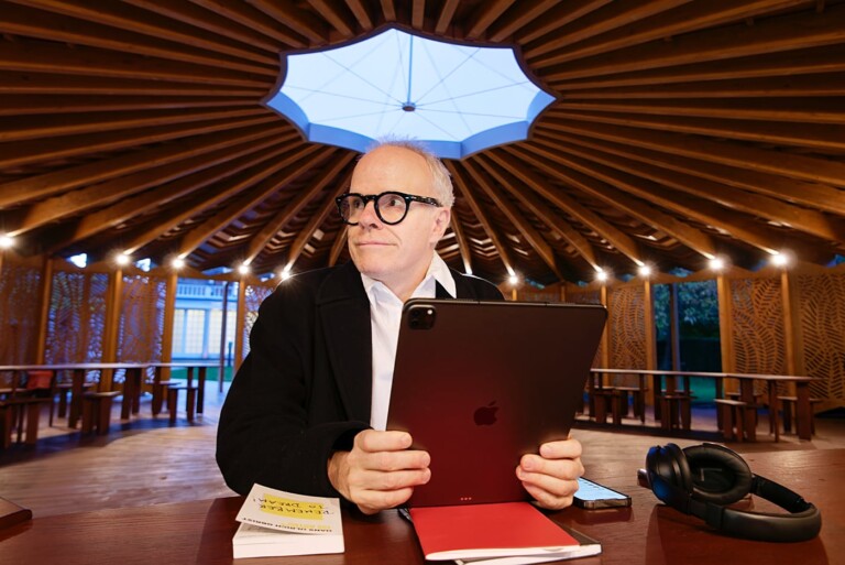 Hans Ulrich Obrist, Artistic Director of the Serpentine Galleries, seen inside the 2023 pavilion holding an iPad