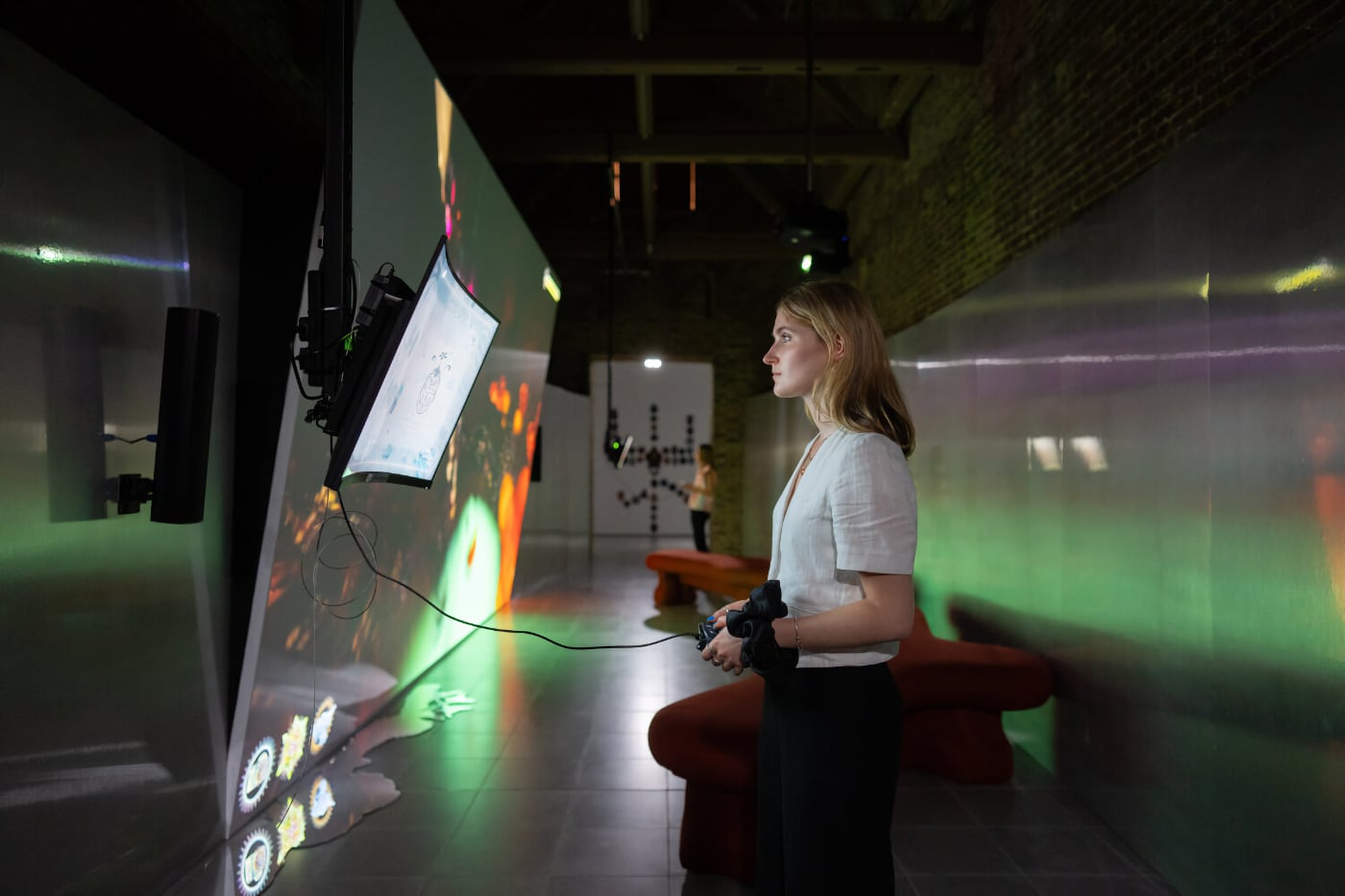 A woman experiencing the interactive media exhibition “Third World: The Bottom Dimension” at Serpentine Galleries in London.