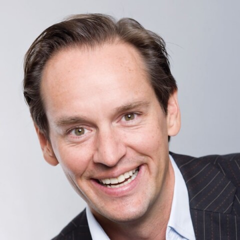 Studio portrait of Patrick Warnking, Google’s Vice President for Central Eastern Europe, smiling in front of a neutral grey background.