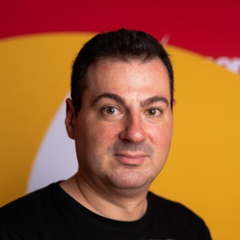 Portrait image of Vlad Ciurca, Co-Founder & Executive Producer of Techsylvania, in front of a colorful background.