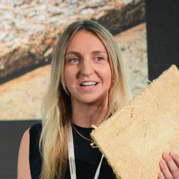 Photo of HopON co-founder Marlene Stechl holding a piece of bio-based building material made from hops