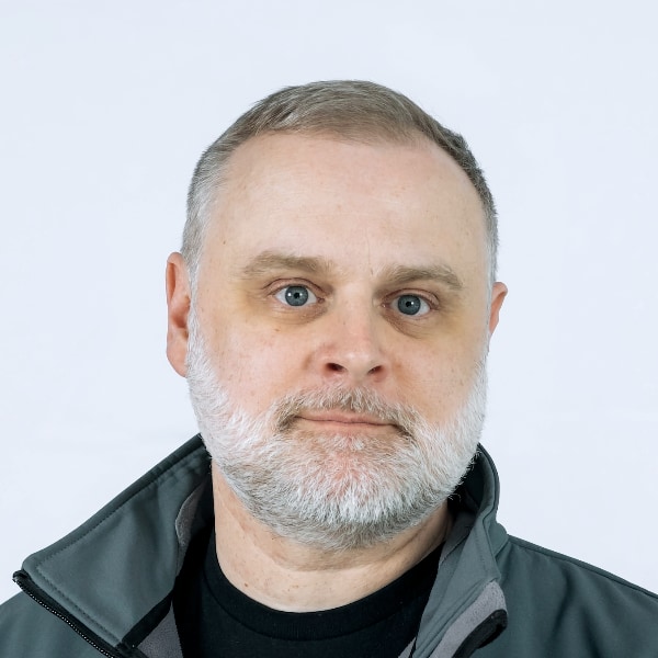 Studio portrait photo of serial entrepreneur Rodolfo Rosini, CEO and co-founder of semiconductor firm Vaire Computing, looking straight at the camera.