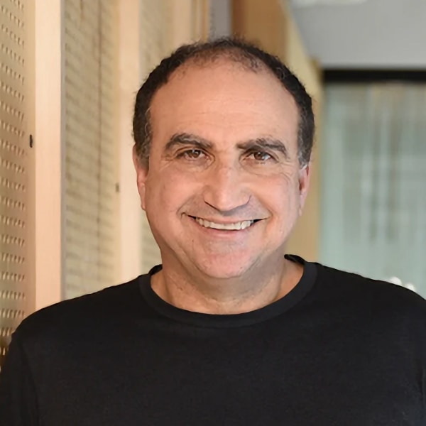 Indoor portrait photo of Google’s Head of Research, Yossi Matias, smiling at the camera.