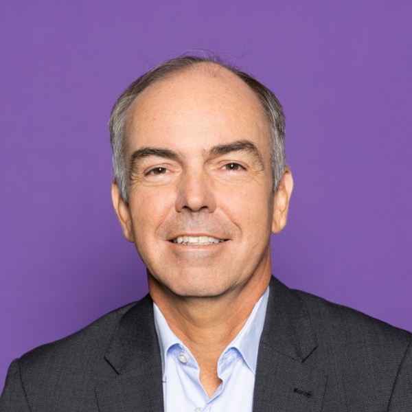 Studio portrait of German computer scientist Dieter Kranzmueller in front of a purple background.