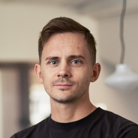 Headshot portrait of Otto Gernandt, CFO of Stegra, standing in a room with a lamp hanging from the ceiling in the background.