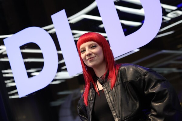 Singer Sophie Louise Scott, known as Sophie & the Giants, standing in front of the DLD logo at the DLD Munich conference 2025.