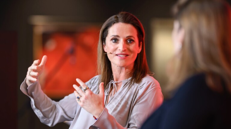 Verena Pausder (German Startup Association) in conversation with Ann-Kristin Achleitner, blurry in the foreground, at the DLD Munich Conference 2025.