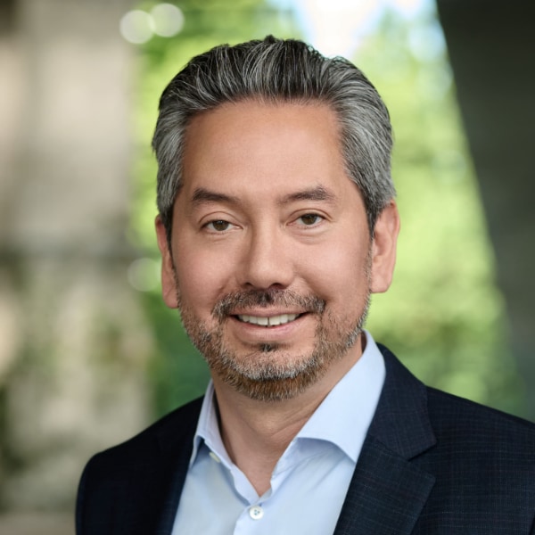 Headshot portrait of BMW manager Glenn Schmidt, seen outdoors in a natural environment.