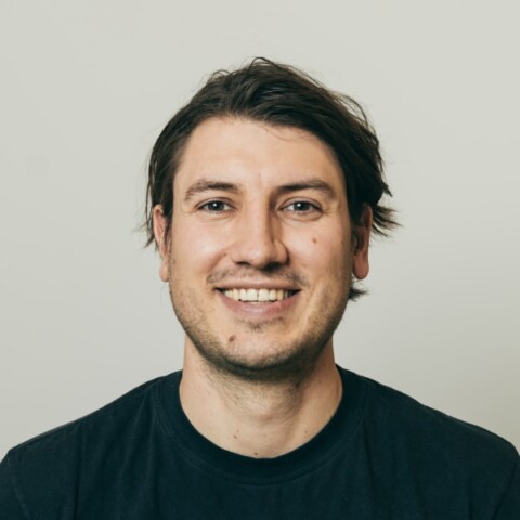 Headshot portrait of climate-tech founder Malte Feucht, CEO of Phlair, in front of a grey neutral background.