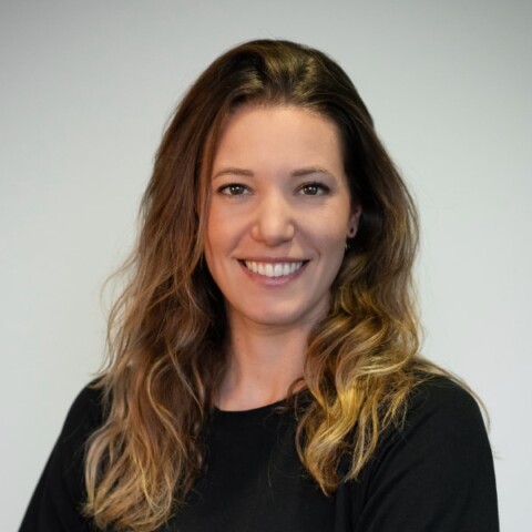 Studio headshot portrait of Anastasia Hofmann, co-founder of KITRO, in front of a neutral grey background.