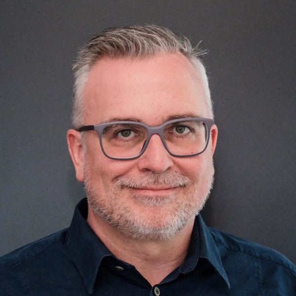 Studio headshot portrait of Christian Kirschniak, Managing Director and Partner at BCG in Germany, in front of a neutral, dark grey background.