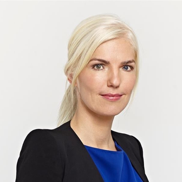 Studio headshot portrait of Europa Bendig, founder of consultancy Sturm & Drang, in front of a neutral grey background.