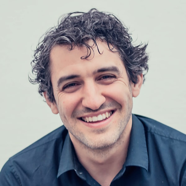 Headshot portrait of Karim Morsy, Algoriddim CEO & Co-Founder, in front of a grey background.