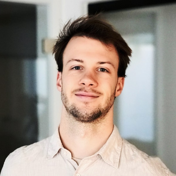 Indoor headshot portrait of Langdock CEO and co-founder Lennard Schmidt, smiling at the camera.