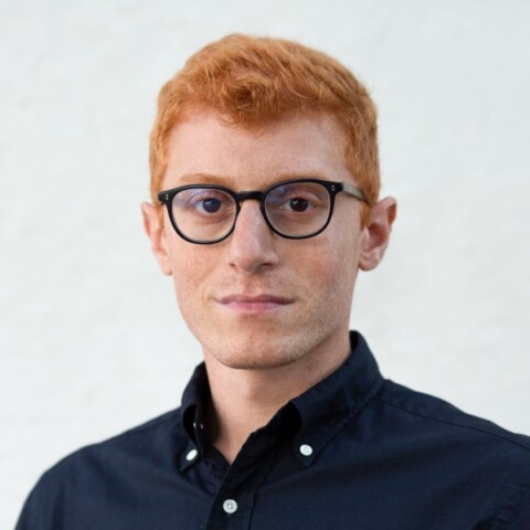 Headshot portrait of Alex Kotran, co-founder and CEO of aiEdu, in front of a neutral grey background.