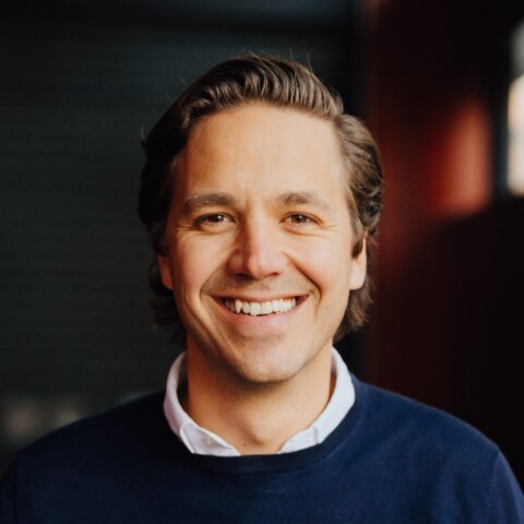 Headshot portrait of Felix Heinricy, Resourcify, in front of a dark background.