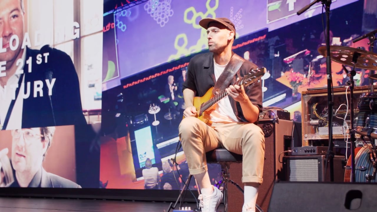DLD Future Hub highlight video screenshot showing a musician on stage on day 1.