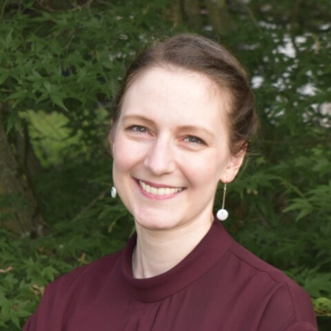 Environmental portrait of Katharina Breininger, AI expert at the University of Würzburg, in an outdoor setting with vegetation in the background.