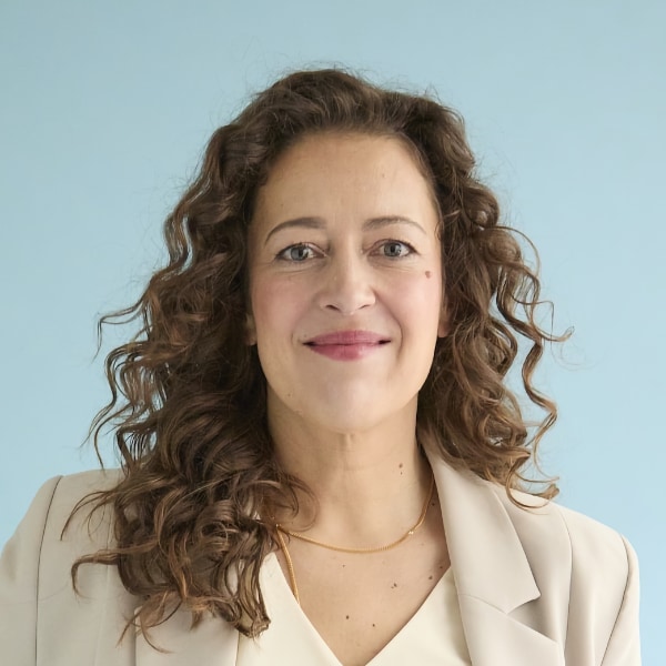 Studio headshot portrait of journalist Mateja Mögel in front of a light blue background
