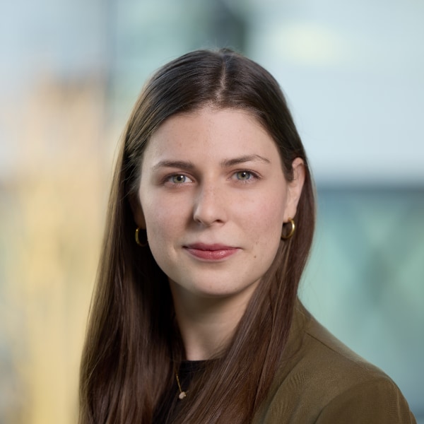 Headshot portrait of SAP manager Sarah Buerkle in front of a blurred colorful background
