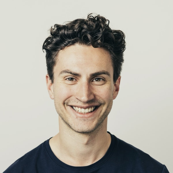 Headshot portrait of Phlair co-founder Steffen Garbe in front of a beige background