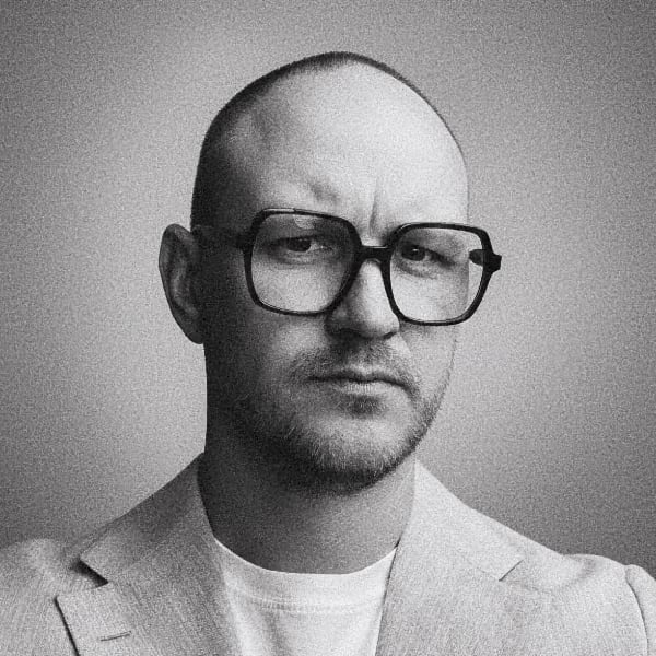 Grainy black-and-white headshot portrait of Sten-Kristian Saluveer, Director of the Tallinn Digital Summit, looking sternly at the camera.