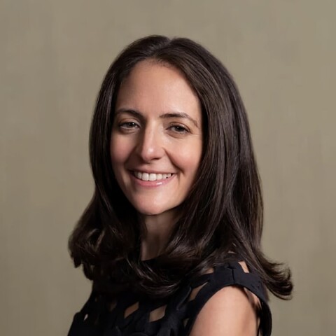 Studio headshot portrait of Stephanie Cohen, Cloudflare, in front of a neutral, light brown background.