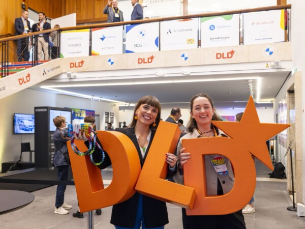 DLD team members carrying a logo of the company.