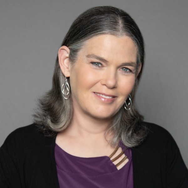Studio headshot portrait of computer scientist Daphne Koller, CEO and Founder of insitro, in front of a neutral grey background.