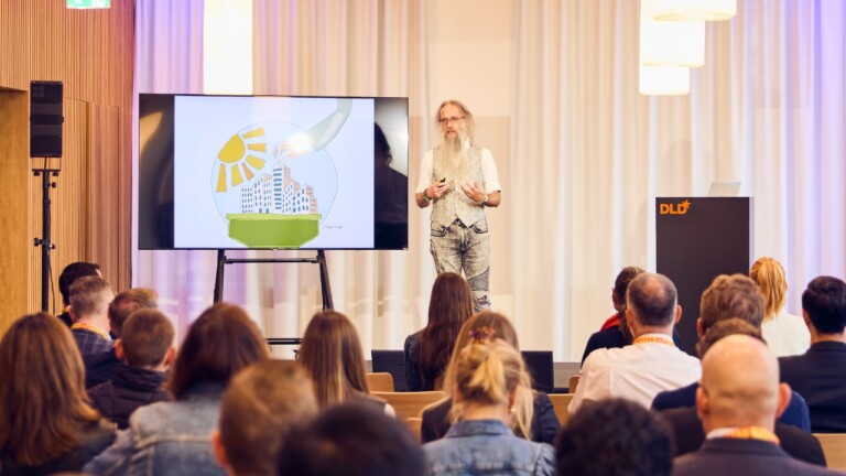Julian Stodd (Sea Salt Learning) speaking at the DLD Future Hub conference in Munich, with the audience visible in the foreground.