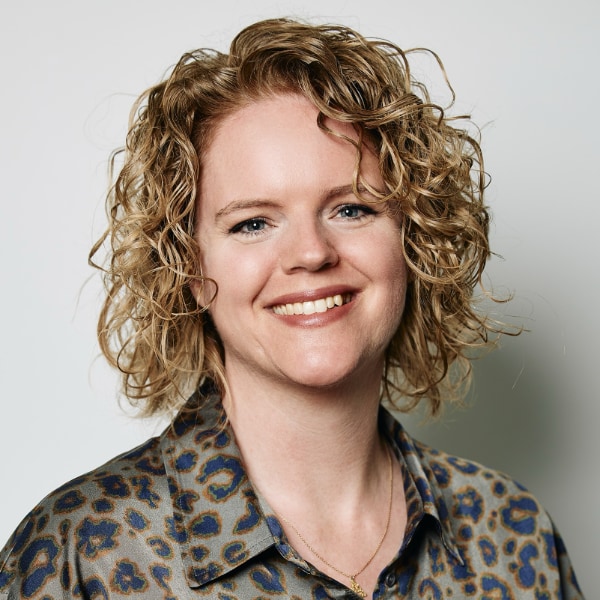 Studio headshot portrait of Alinda Vermeer, Executive Director of the Limelight Foundation, in front of a light grey background.