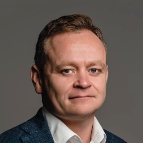 Studio headshot portrait of Andrii Dykun, Ukrainian Agri Council, in front of a dark grey background.