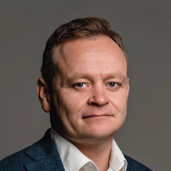 Studio headshot portrait of Andrii Dykun, Ukrainian Agri Council, in front of a dark grey background.