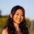 Environmental portrait of Julia Zhou, Tidal Impact, seen outdoors in nature, smiling at the camera.