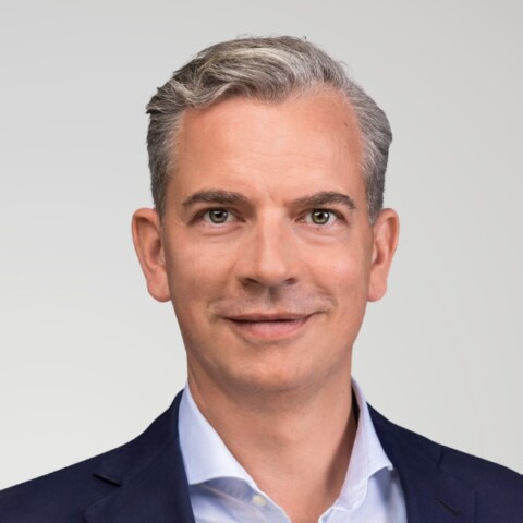 Headshot portrait of Matthias Voelkel, CEO of B&ouml;rse Stuttgart Group, in front of a grey studio background.