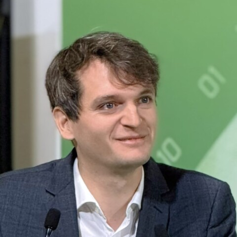 Raidium co-founder Pierre Manceron, speaking at a conference, looking to his left.
