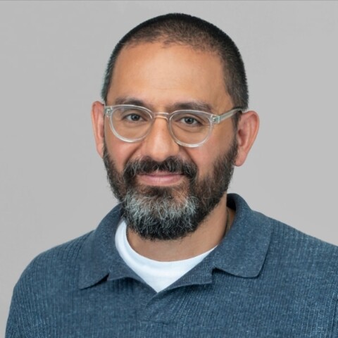 Portrait of Raffi Krikorian, CTO of Mozilla, in front of a grey studio background.
