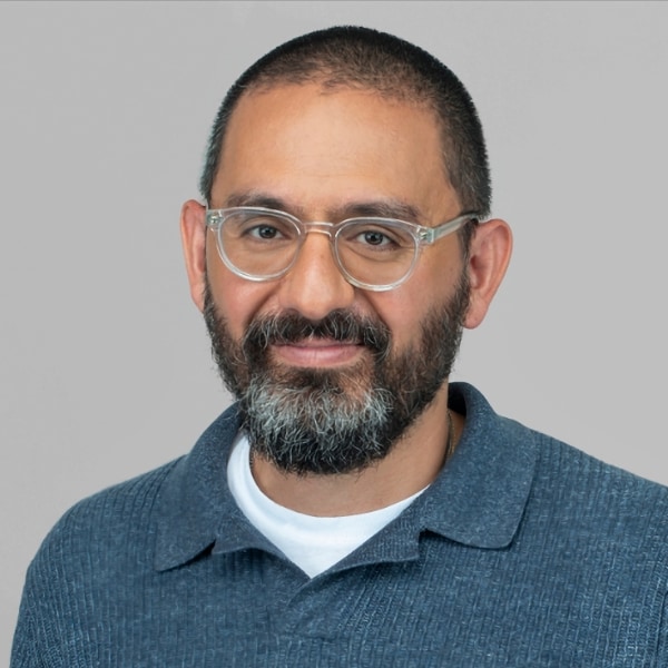 Portrait of Raffi Krikorian, CTO of Mozilla, in front of a grey studio background.