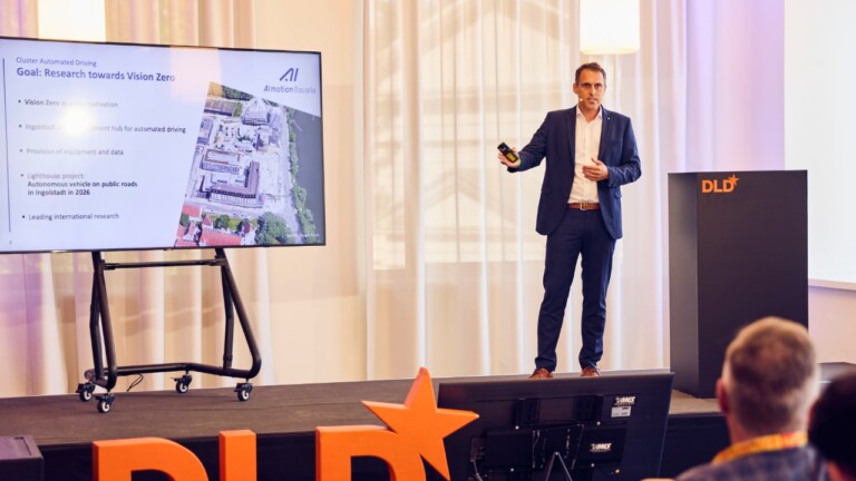 Torsten Schoen (Almotion Bavaria Institute) on stage at the DLD Future Hub conference in Munich.