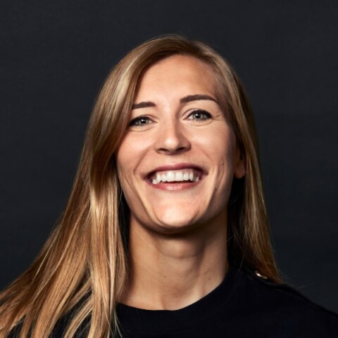 Portrait of Swedish investor Agate Freimane in front of a black studio background.
