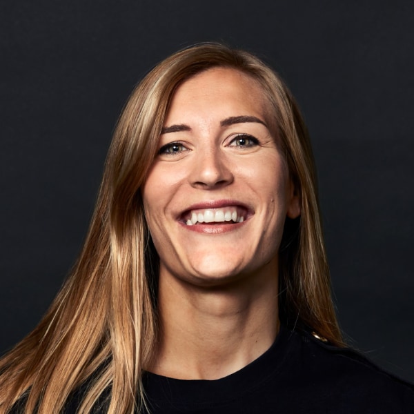 Portrait of Swedish investor Agate Freimane in front of a black studio background.