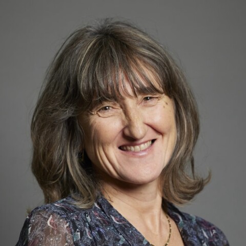 Portrait image of Baroness Beeban Kidron in front of a grey studio background.